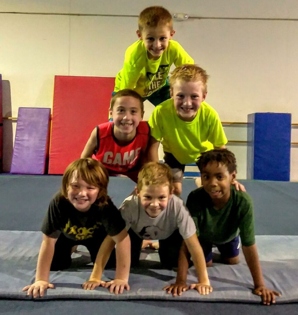 A group of kids standing on top of each other.