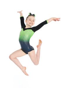 A young girl in a green and black leotard jumping.