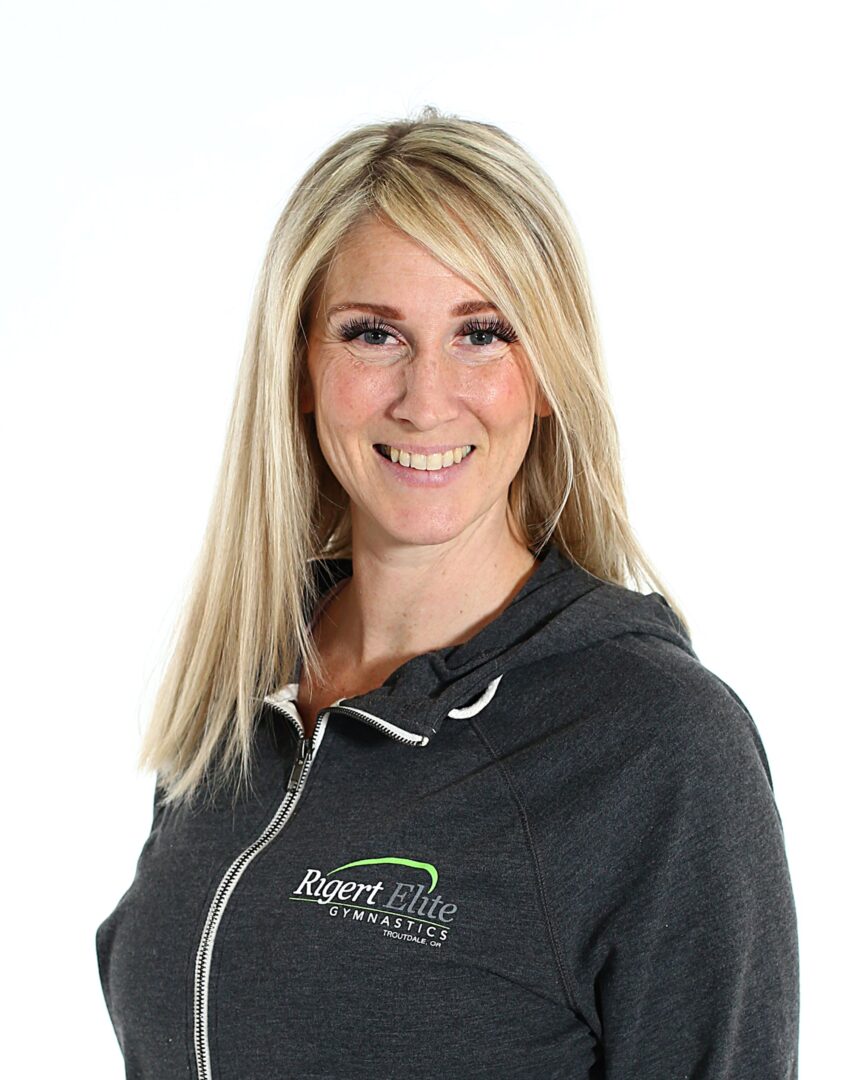 A woman wearing a black hoodie with green and white lettering.