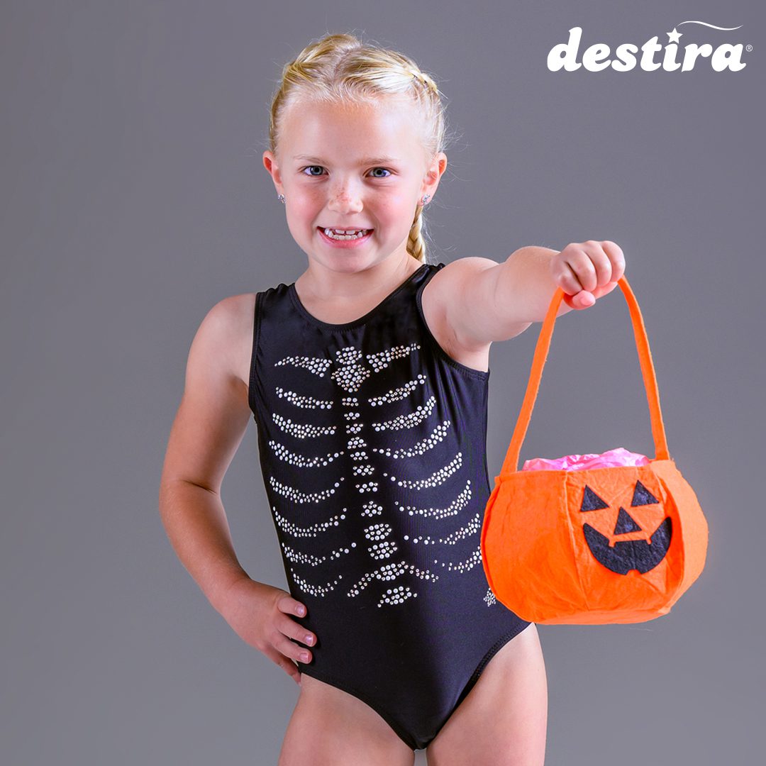 Girl in skeleton leotard with pumpkin bag.