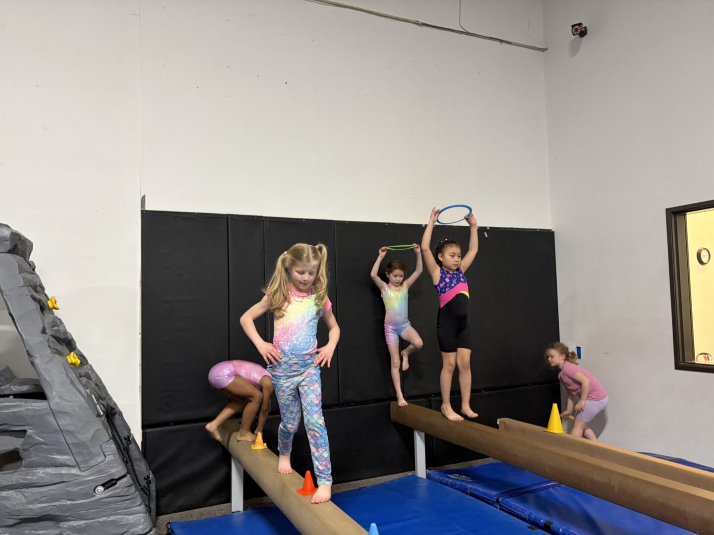 Young girls practicing on balance beams