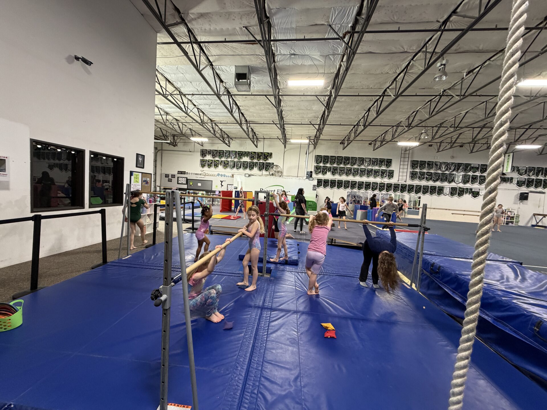 Kids practicing gymnastics on bars in gym