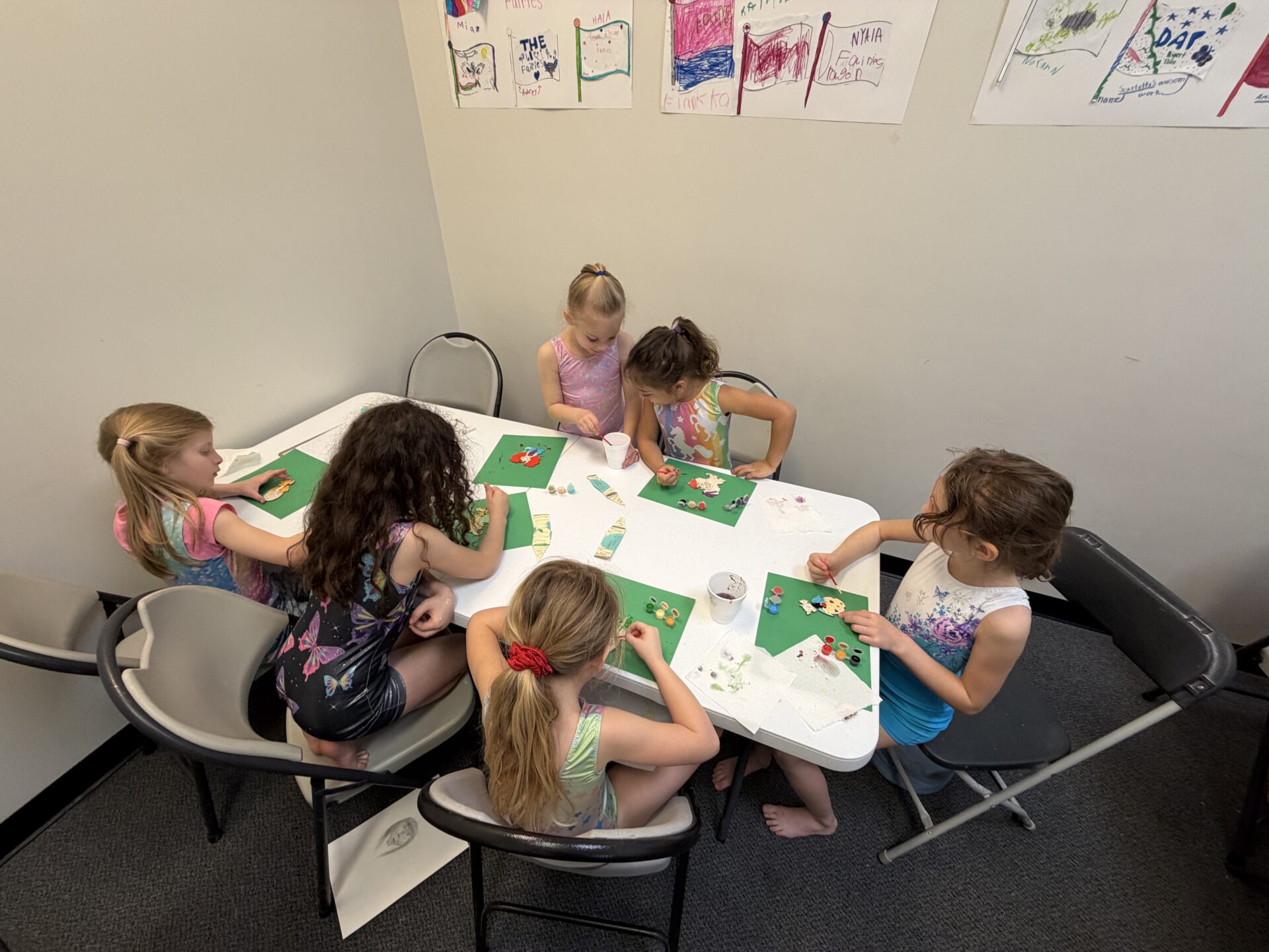 Children crafting together around a table